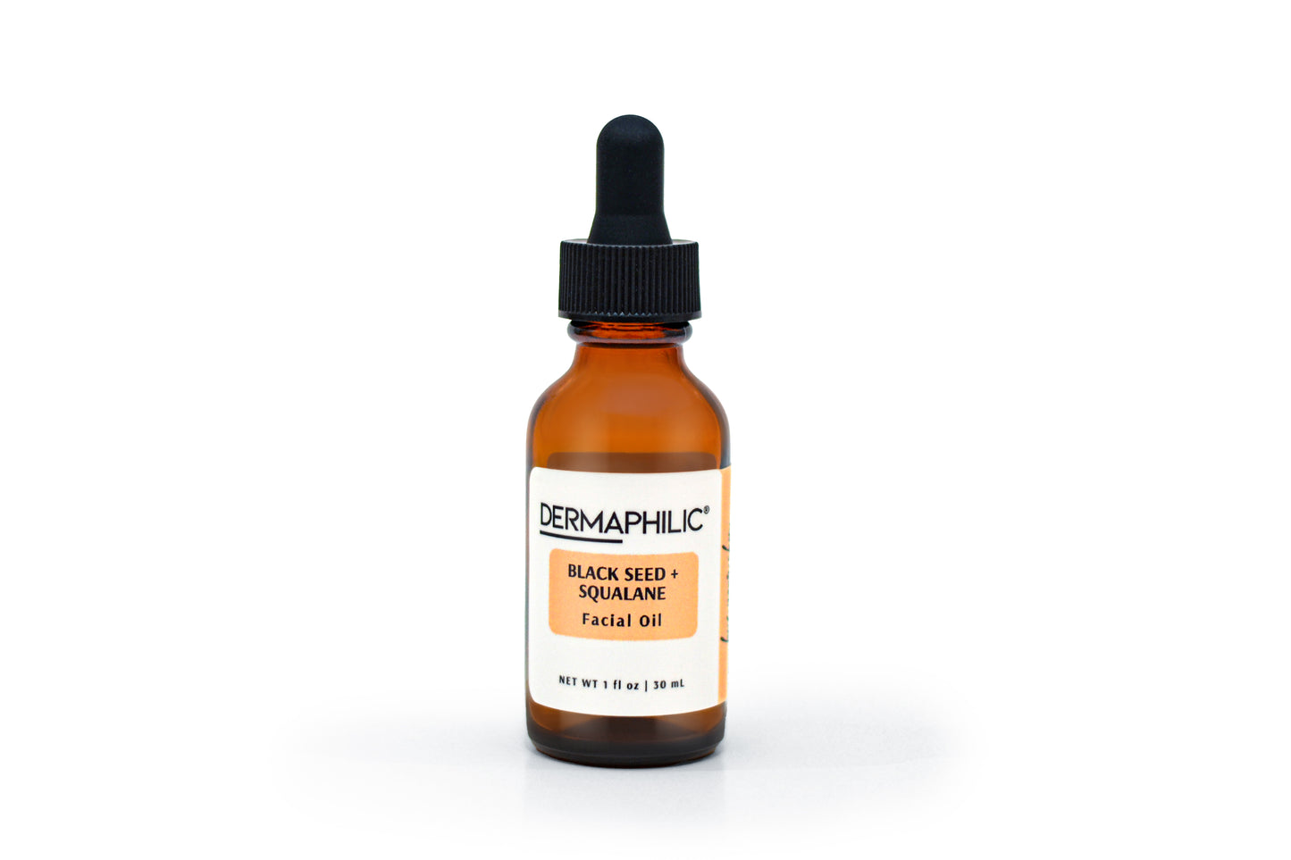 Amber glass bottle with dropper labeled 'Dermaphilic Black Seed + Squalane Facial Oil' on a white background